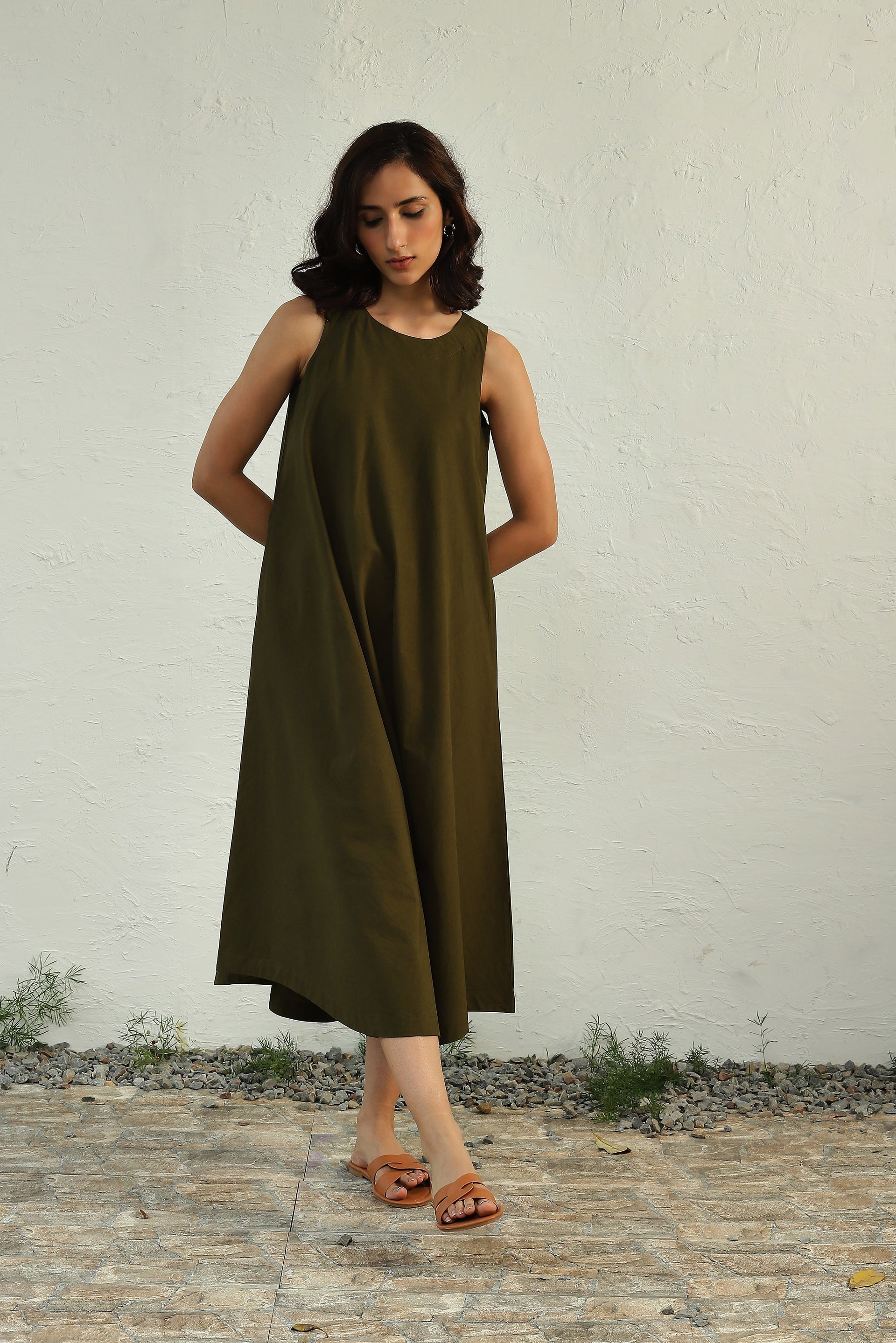 Elevate your style with our earthy green sleeveless midi dress.  Canoopi